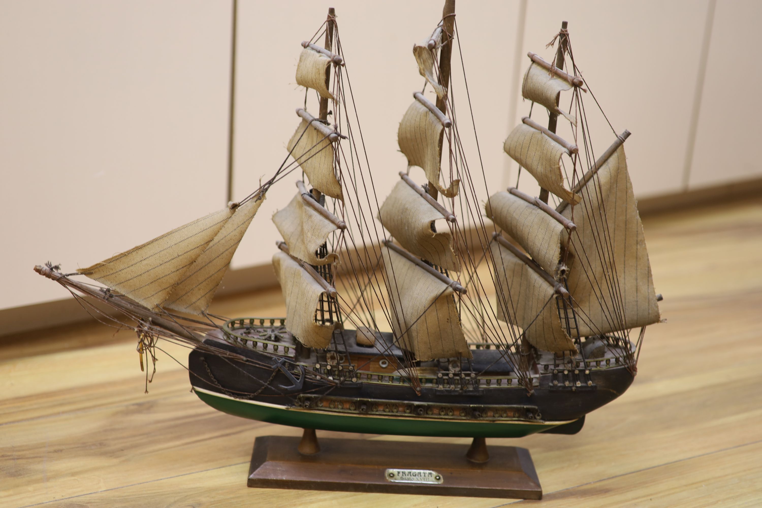 Three model ships: The Cutty Sark, The USS Constitution and Fragata, together with a carved wood Marlin